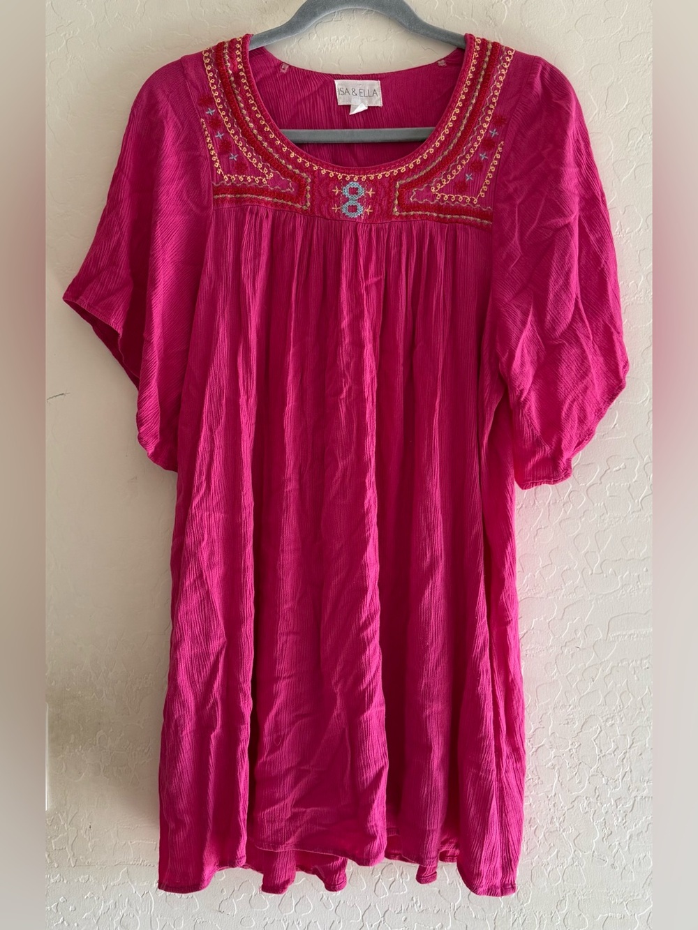 Isa & Ella, large, magenta pink dress featuring a vibrant embroidered neckline
